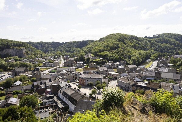 A town with historic buildings, a river, and a hill in the background. - Holiday Home in Grand Est (Signy-l’Abbaye)