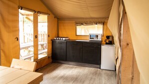 A compact kitchen with a gas stove, microwave, and a small refrigerator. - Terrace Apartment with Forest (Dochamps)