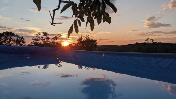 A swimming pool reflecting the sunset with a clear sky and distant hills. - DOUBLE TENTS FOR 4 PEOPLE IN THE HEART OF NATURE! Espace ERICA (Saint-Projet)