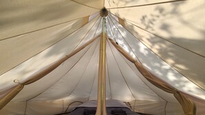 A tent with a central pole and guy lines, a sleeping area with a blue blanket, and a ground mat. - DOUBLE TENTS FOR 4 PEOPLE IN THE HEART OF NATURE! Espace ERICA (Saint-Projet)