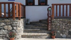 A stone staircase leading to a building with a wooden railing and a sign reading 'La Badia.' - La Badia – Il Vigneto🌿 | Breathtaking View of Vesuvius and the Gulf of Naples (Vico Equense)