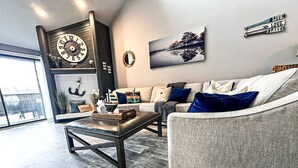 A modern living room with a sofa, coffee table, and decorative items.