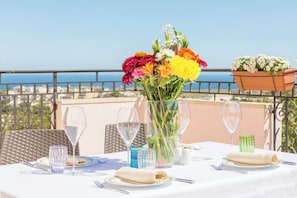 Enjoy a romantic meal for two on the outdoor terrace with a stunning sea view.
