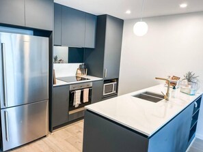 Fridge, stovetop, dishwasher, coffee/tea maker