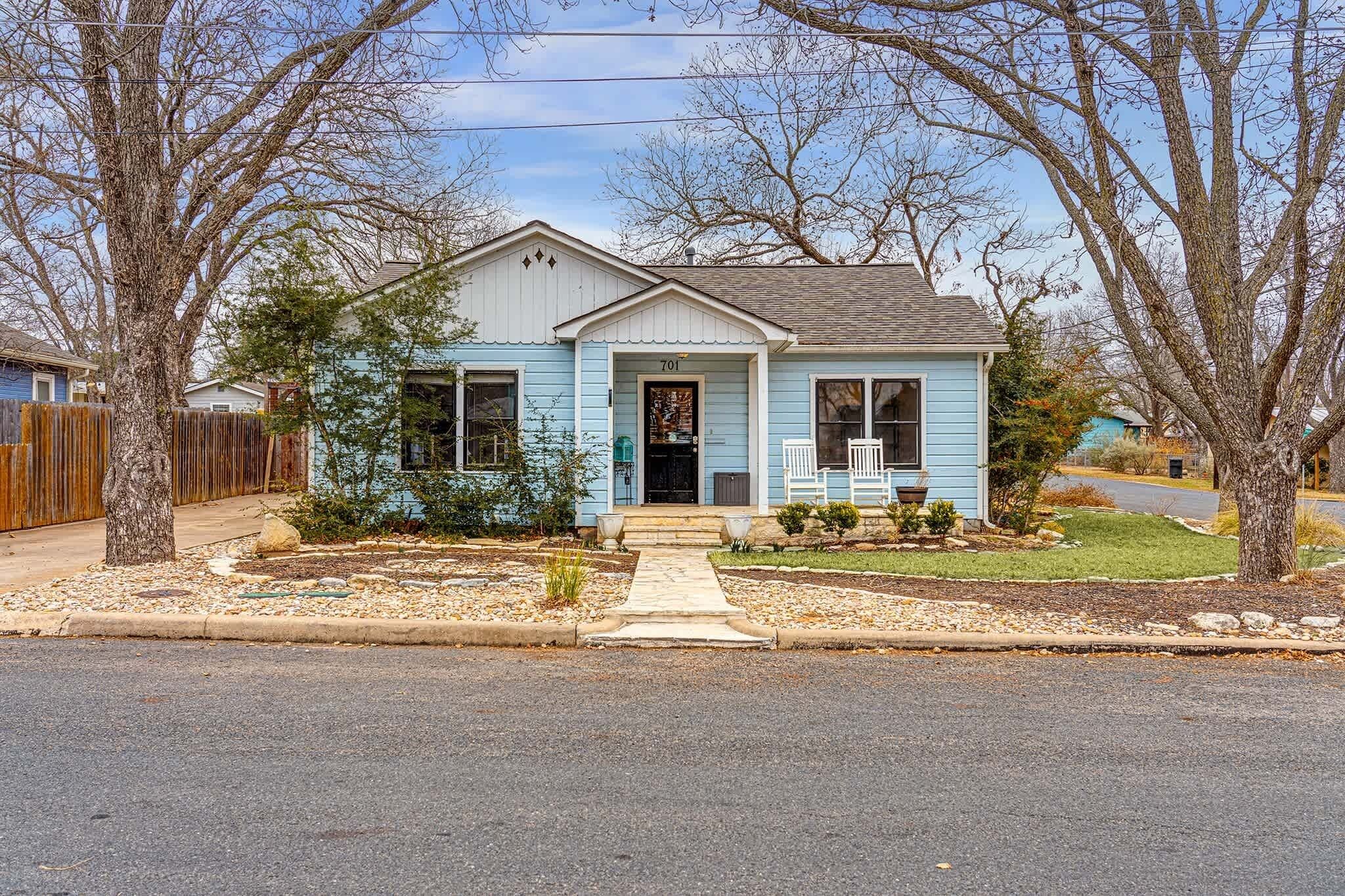 A single-story house with a front porch, a mailbox, and a number '701' on the door.