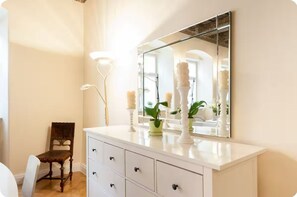 Relax in style with a spacious vanity, mirror, and comfortable reading chair.