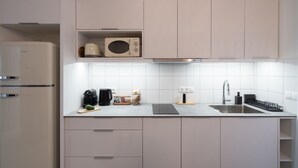 A modern kitchen with a built-in microwave, coffee maker, and a double sink. - Acropolis Walk • Starlink • Sunset Rooftop (Athens)