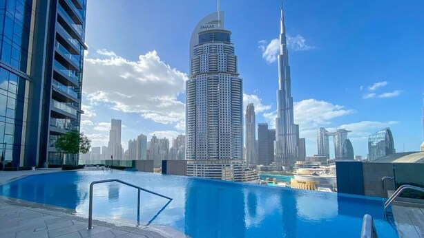 A rooftop pool with a view of the Burj Khalifa and surrounding high-rise buildings. - Westminster Boulevard Point (Dubai)