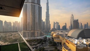 A high-rise building with a curved facade, a large dome structure, and a prominent skyscraper in the background. - Westminster Boulevard Point (Dubai)