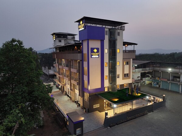 A multi-story hotel with a prominent sign reading "COZZET MAHAJ" on the facade. - Cozzet Mahad (Mahad)