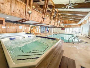 An indoor swimming pool with wooden beams and a hot tub area. - Chimney Hill Haven | Close to Mt.Snow (Wilmington)