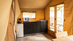 A compact kitchen with a microwave, stove, and refrigerator. - Terrace Apartment With Forest (Manhay)