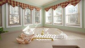 A bathroom with a freestanding bathtub, a towel, and a plant. - Dream Chaser: Minutes from Dollywood & Downtown (Pigeon Forge)