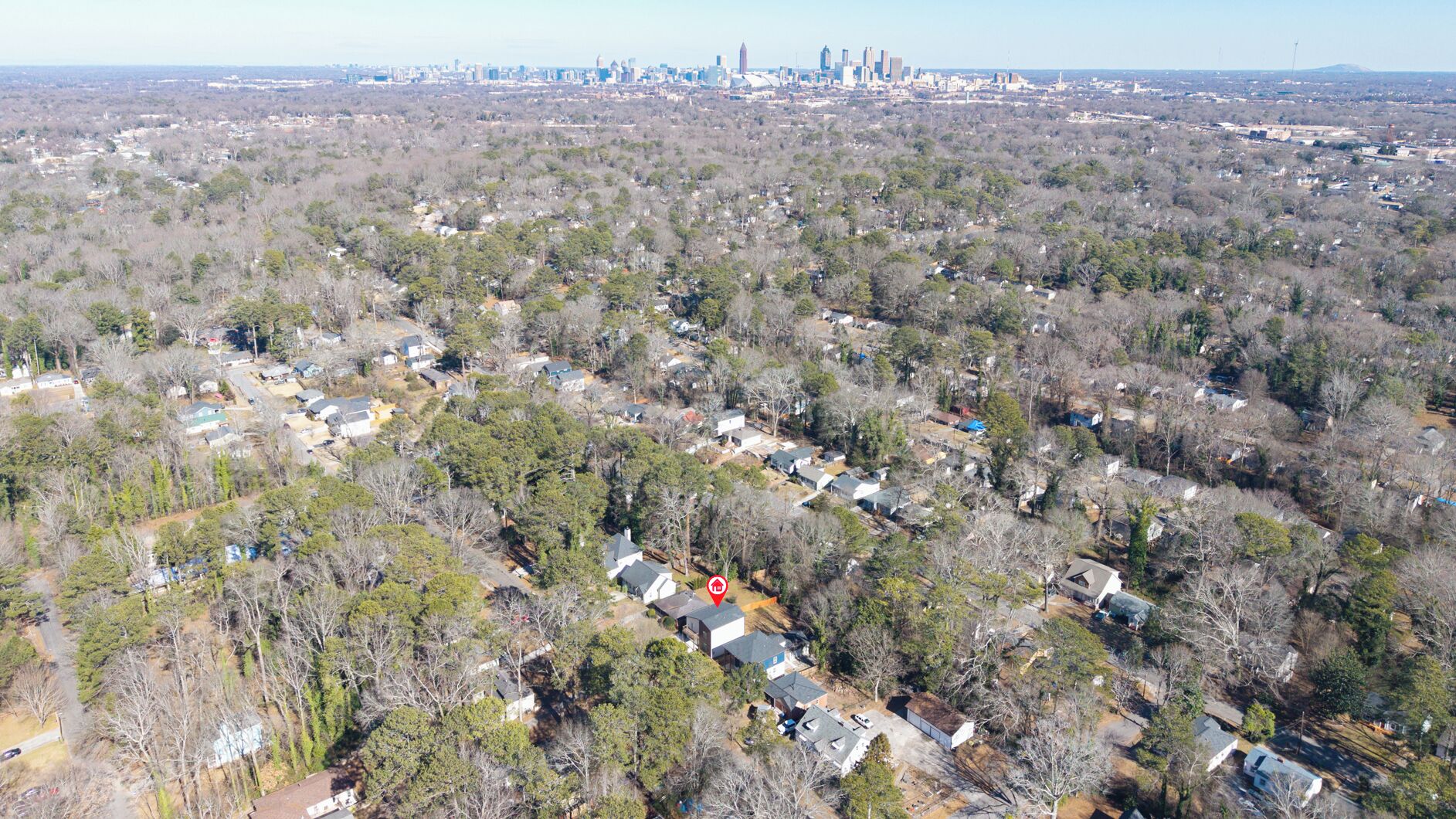 An aerial view of a residential area with houses surrounded by trees.