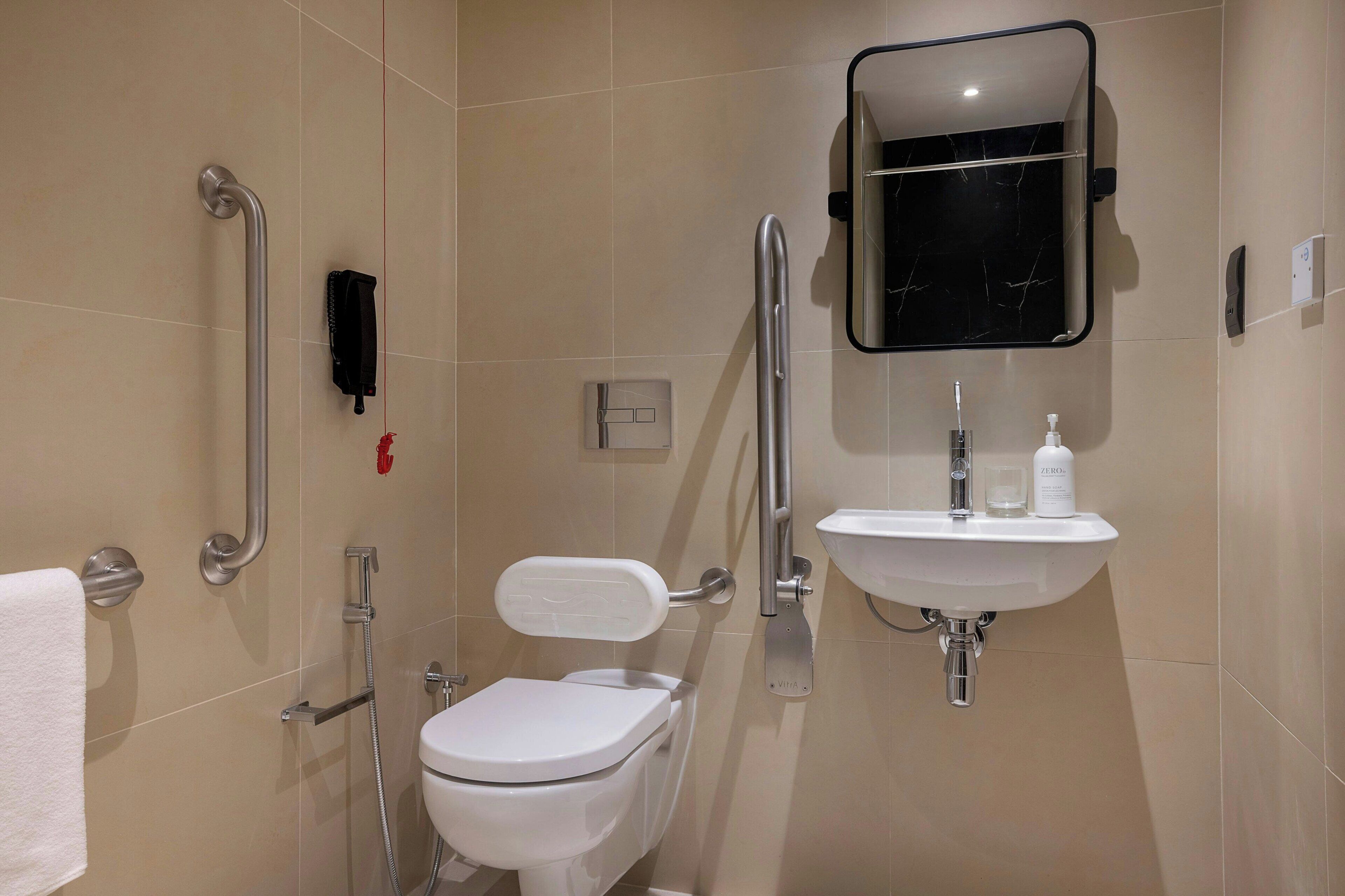 A modern bathroom with a toilet, bidet, and sink.