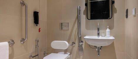 A modern bathroom with a toilet, bidet, and sink.