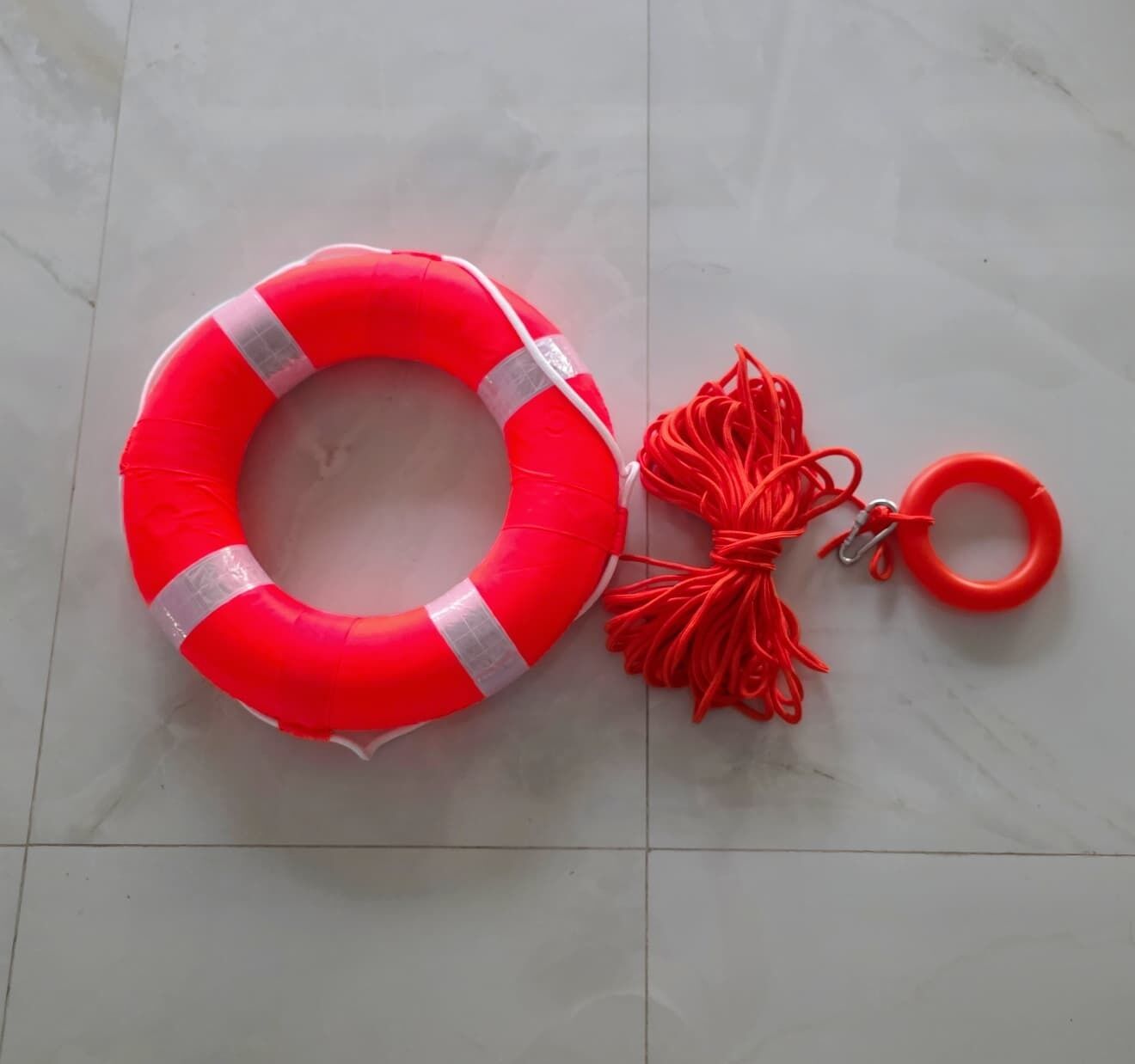 A red life preserver with a white band and a keychain with a red ring.
