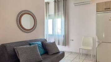 Basic Apartment, 1 Queen Bed with Sofa bed, Balcony, Beachfront | Living area | Flat-screen TV