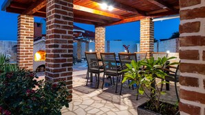 An outdoor patio with brick pillars, a wooden ceiling, and a stone floor. - Villa Mendula Zadar Villas (Novigrad)