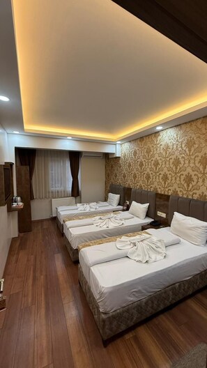 A hotel room with a large bed, a smaller bed, a sofa, a desk, and a mirror. - FORTYNINE HOTEL (Istanbul)