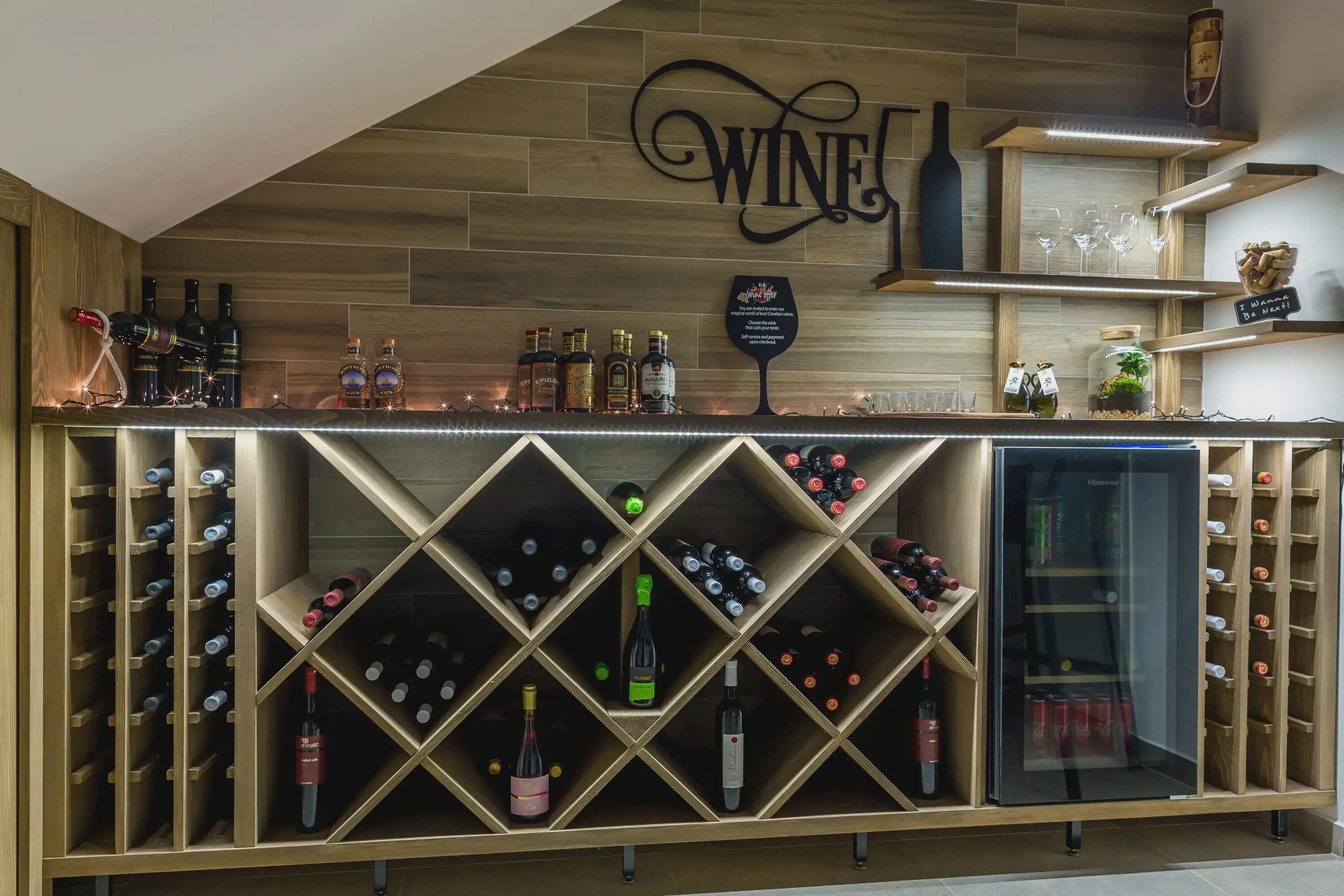 A wine bar with a wooden backdrop and a sign that reads "WINE".