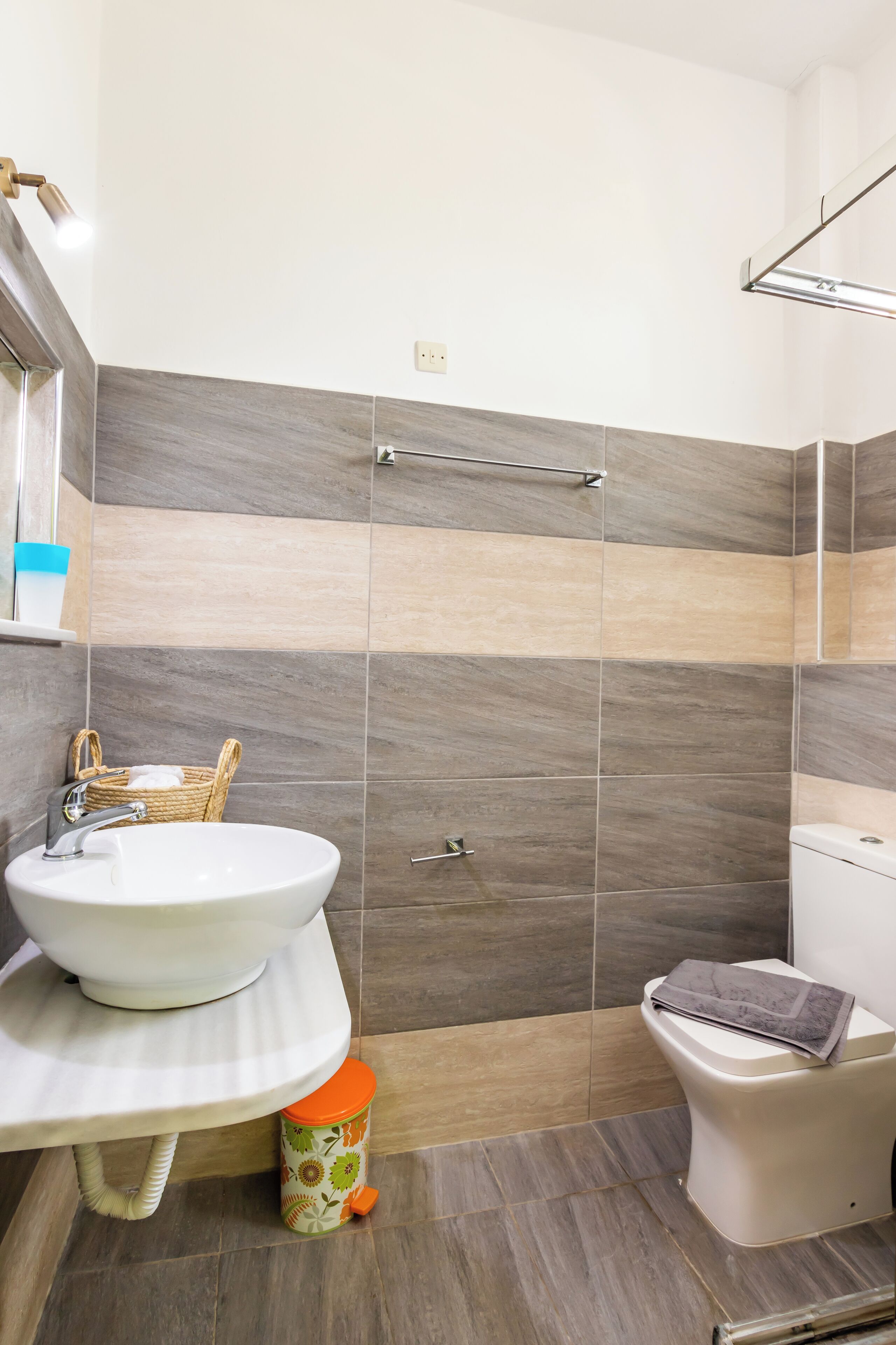 A bathroom with a white sink, a toilet, and a shower area.
