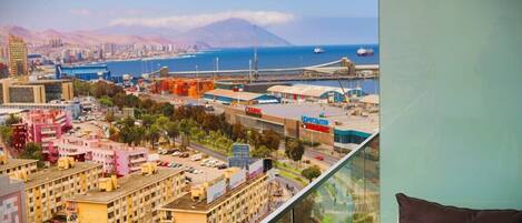 Enjoy breathtaking views of the coastal cityscape from this high-rise's expansive balcony.