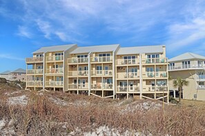 A multi-story hotel with balconies, located near a beach with sandy dunes. - Sea Cliff A5 - Sunset Shores (Port St. Joe)
