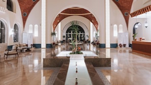 A spacious lobby with a central water feature, arched ceilings, and a reception desk. - Diamond Beach (El Quseir)