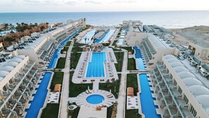 A resort with multiple swimming pools, a central fountain, and a beach area. - Diamond Beach (El Quseir)