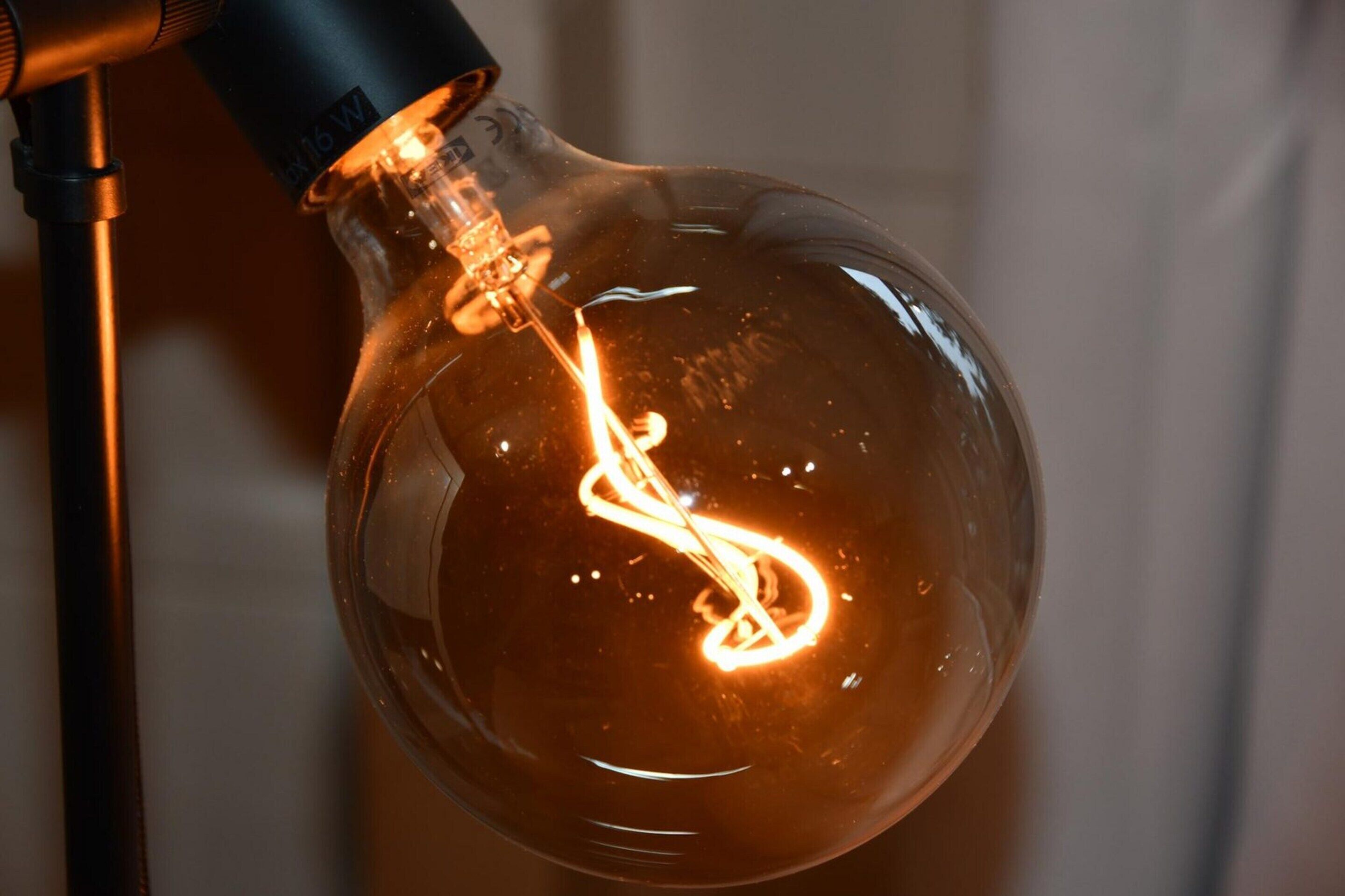 A close-up of a light bulb with a filament inside.