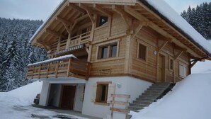 A wooden chalet with a balcony, a staircase, and a sign reading "LE PANORAMA." - Chalet, wifi, view mountain, terrace, balcony, parking, ski locker, 152m², Le Grand Bornand (Le Grand-Bornand)
