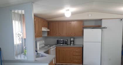 Room in mobile home with WiFi, AC, free washer & dryer. 5 miles from Blue Oval