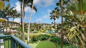 A resort with multiple buildings, a pool area, and lush greenery.