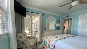 A bedroom with a bed, a chair, a dresser, and a ceiling fan. - SeaMaster 110: Oceanfront 3 bed 3 bath condo (Murrells Inlet)