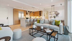 A modern living room with a sofa, ottomans, and a coffee table. - Frontgate 228 - 3 Bedroom Residence (Avon)