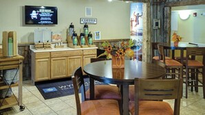 A restaurant with wooden furniture, a coffee station, and a television displaying a message. - Available February 17-21 2025. Sleep 8 - 2-bed apt on Jiminy Peak.  Ski in/out! (Hancock)