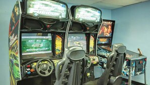 A row of arcade machines with racing game themes, including 'The Fast and the Furious' and 'Up to 1'. - Available February 17-21 2025. Sleep 8 - 2-bed apt on Jiminy Peak.  Ski in/out! (Hancock)