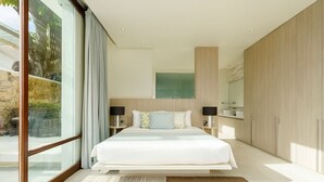 A modern bedroom with a large bed, a glass wall, and a view of the outdoors. - Samujana Villas - Villa Karawek (Bo Put)