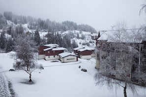 A snow-covered residential area with houses and trees.