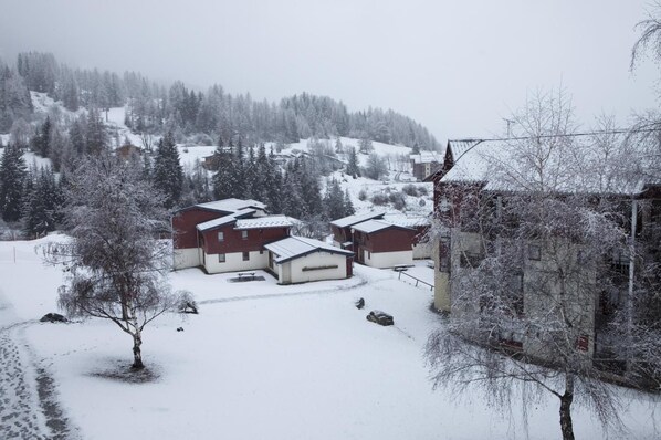 A snow-covered residential area with houses and trees.
