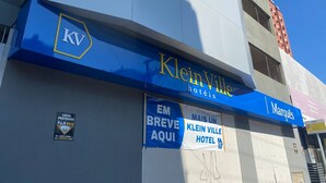 The exterior of KleinVille Hotel with a blue awning and signage. - Kleinville Marquês (Sao Leopoldo)