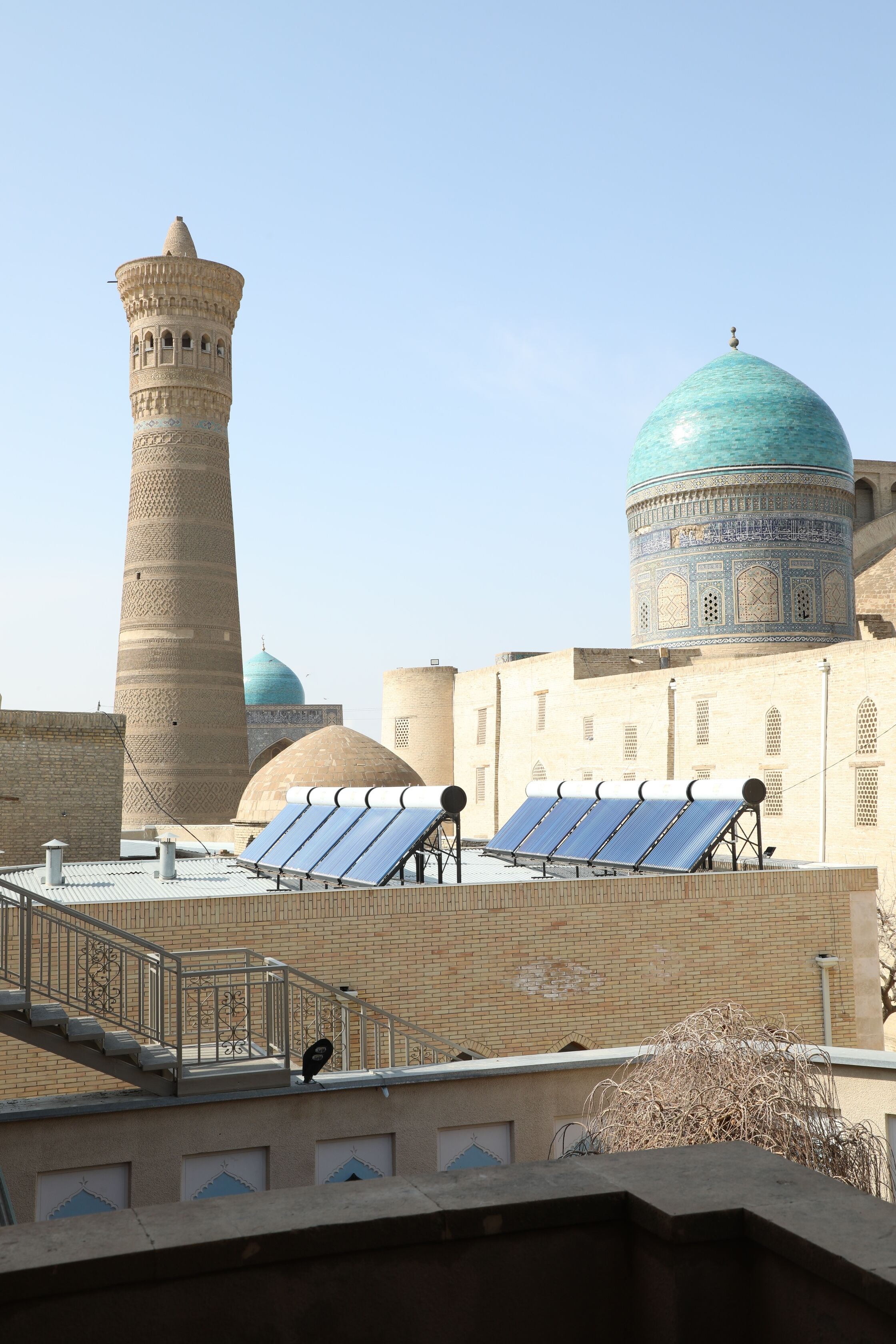 A building with a tall tower and a dome with intricate patterns.