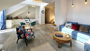 Comfort Apartment, Balcony | Living area | 50-inch LCD TV with cable channels