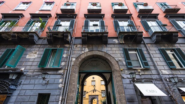 A building with a central archway, multiple balconies, and a sign reading "CASO". - Bisignano 11 in Naples (Naples)