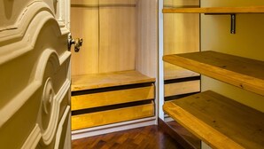 A room with wooden shelving units, a wooden door, and a wooden floor. - Bisignano 11 in Naples (Naples)