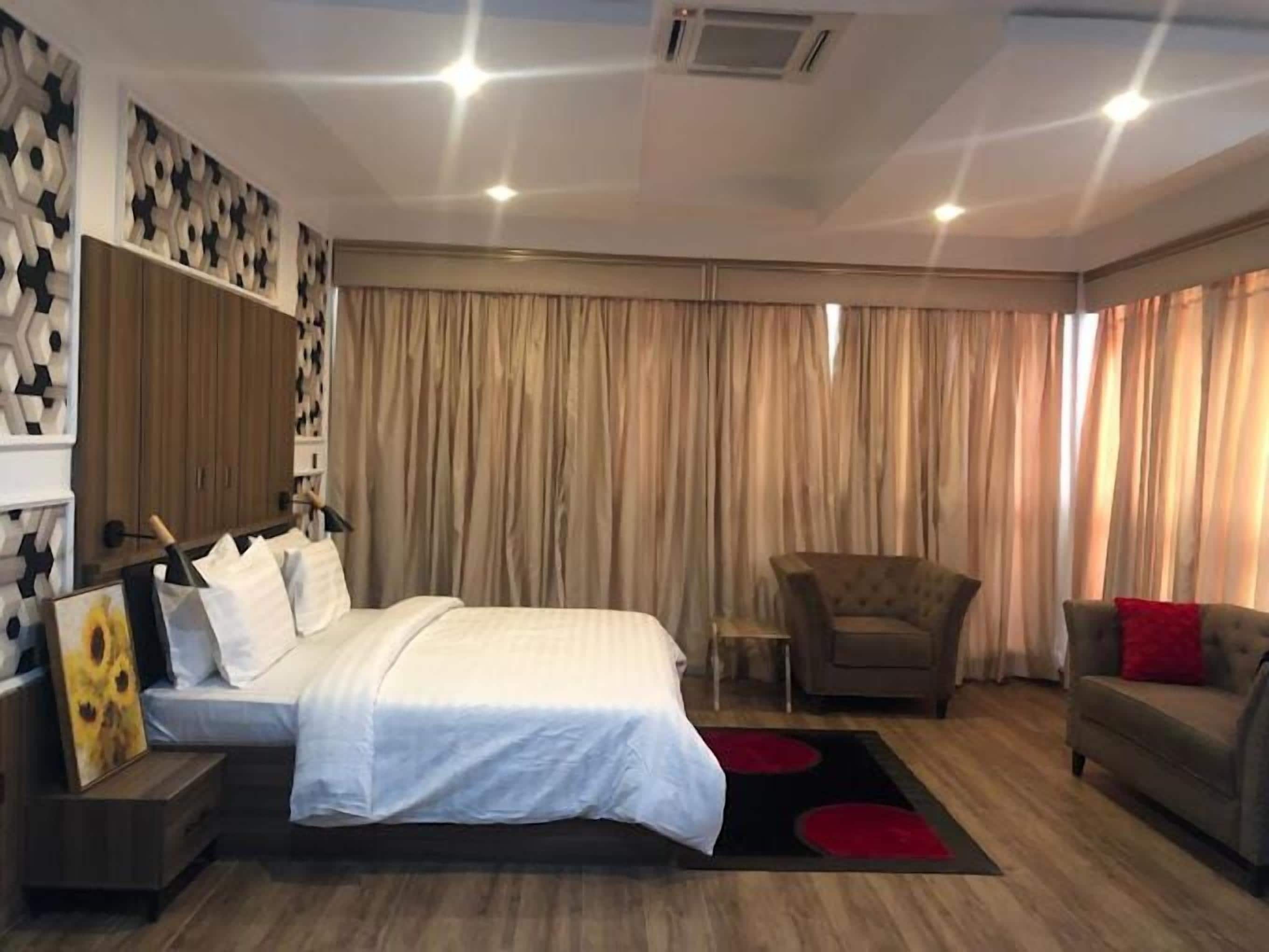 Deluxe Apartment, Balcony, City View | In-room safe, desk, laptop workspace, blackout drapes