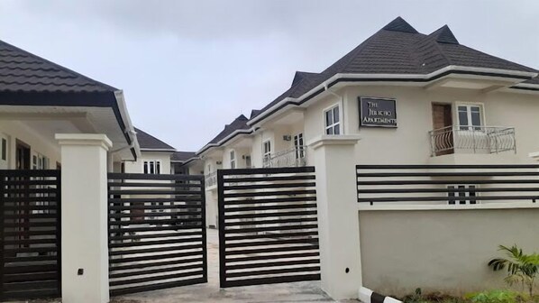 A gated residential complex with a sign indicating "The Public Apartments."