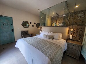 A bedroom with a large bed, a dresser, a chair, and a mirror. - Castello di Carlo - Suite Carlo I (Tetlatlahuca)