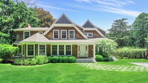 Traditional two-story house with a central entrance and symmetrical facade.